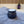 Load image into Gallery viewer, A black plastic cauldron filled with bath bomb ingredients. The cauldron sits on a gray towel with a bathtub and purple and black lantern in the background.
