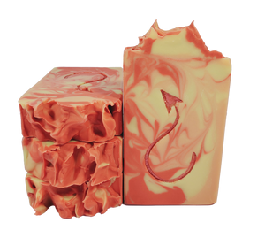 Four bars of Jersey Devil soap, with red, orange, and yellow swirls and a red devil tail on the bar face