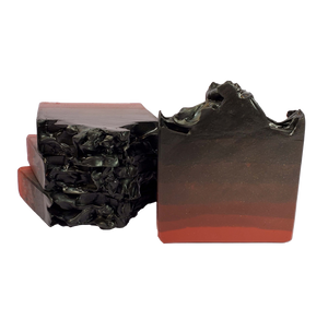 Four bars of The Devil soap. Each bar is shimmery and has an ombre effect from deep red on the bottom to black on the top.