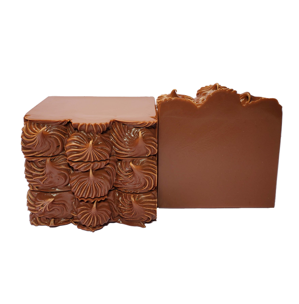 Four bars of Ixcacao soap. The bars are dark brown and are piped on top to look like fudge icing.