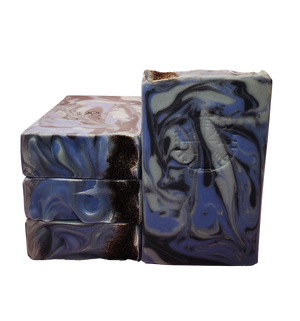Four bars of Valkyrie soap. The bars contain swirls of blue, dark blue, and gray and are topped with Icelandic black sand. The bars are stamped with the Vegvisir stave, also known as the Viking Compass.