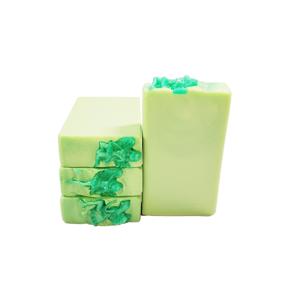 Four bars of bright green soap with green glitter and glittery green soap fairies on top.