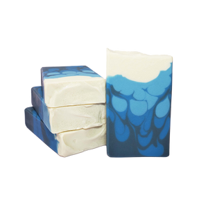 Four bars of Beira soap. The bars are swirls of three shades of blue topped with white, with glitter on top.