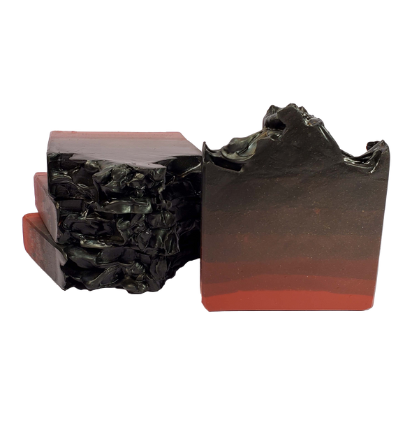 Four bars of The Devil soap. Each bar is shimmery and has an ombre effect from deep red on the bottom to black on the top.