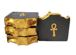 Four bars of Isis soap, which are black with a gold top and a gold ankh.