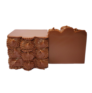 Four bars of Ixcacao soap. The bars are dark brown and are piped on top to look like fudge icing.
