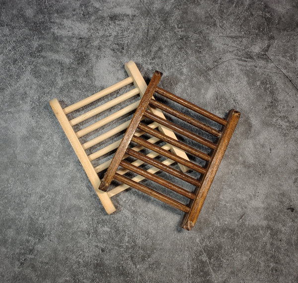 Two wooden soap ladders, one light wood and one dark stained wood, against a gray background.