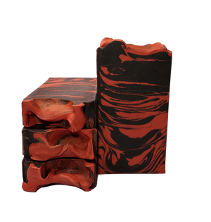 Four bars of Succubus soap. Each bar contains black and red swirls.