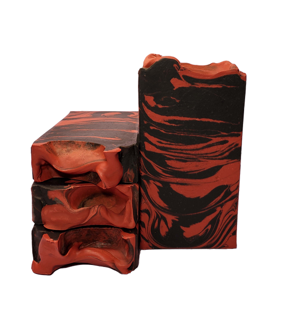 Four bars of Succubus soap. Each bar contains black and red swirls.